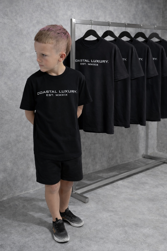 LITTLE LUXURIES. COASTAL LUXURY. (YOUTH) PREMIUM SILHOUETTE BLACK TEE