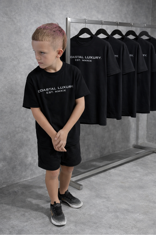 LITTLE LUXURIES.                                            COASTAL LUXURY.             (YOUTH) PREMIUM SILHOUETTE BLACK TEE